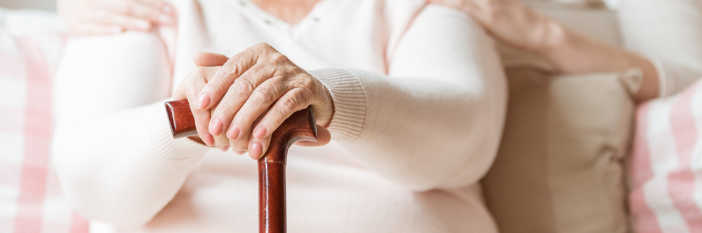 Elderly women holding cane